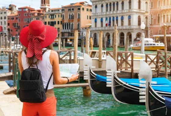 Female-tourist-with-map-in-her-hand-in-Venice-Italy.jpg